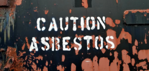 wall with asbestos caution